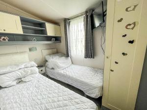 a small room with two beds and a window at Modern 6 Berth Caravan For Hire At Fantasy Island In Skegness Ref 58009d in Skegness