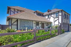 a house with a fence in front of it at Villa Jules, Oceanfront, Private Beach, Fire Pit in Oceanside