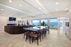 a dining room with a table and chairs and the ocean at Villa Jules, Oceanfront, Private Beach, Fire Pit in Oceanside
