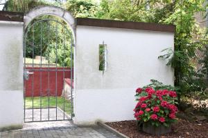 a gate with a bunch of flowers in front of a garage at Berl Inn in Berlin +15 photos