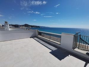 a balcony with a view of the ocean at Seafront apartment in Blanes S'Abanell Central Park in Blanes