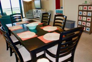 a dining room table with chairs and a dining room at Holiday Isle 107 in Dauphin Island