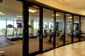 a gym with treadmills and elliptical machines at Holiday Isle 107 in Dauphin Island