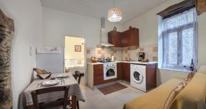a kitchen with a washer and dryer in a room at Feneri- cozy Apartment 20' from Elafonisi beach in Perivólia