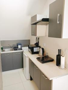 a kitchen with a counter top with a microwave at Apartament na Glinkach 22 in Augustów