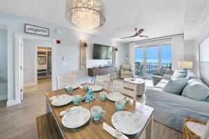 a living room with a couch and a table at Calypso 3 Luxury Beach Vacation Sleeps 8 in Panama City Beach