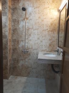 a bathroom with a sink and a shower at Northern Suites Bahria town in Rawalpindi