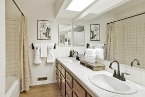 a bathroom with two sinks and a large mirror at Soaring Pines by Big Bear Vacations Central Cozy Estate Chalet in Big Bear Lake +33 photos