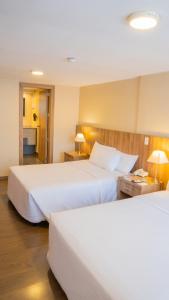 Postel nebo postele na pokoji v ubytování Fenix Hotel