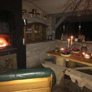 a bar with a fireplace and a table with candles at Lepiej trafić nie mogliście in Mieroszów