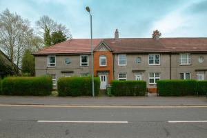 a house on the side of a street at Cosy & Central 2BD Apartment Milngavie, Glasgow in Milngavie