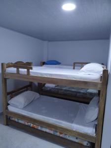 three bunk beds in a room with a ceiling at Apartamentos Vistas del Caribe Sede Campestre in Cartagena de Indias