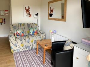 a living room with a chair and a table at Cloverleaf in Saltfleetby Saint Clement