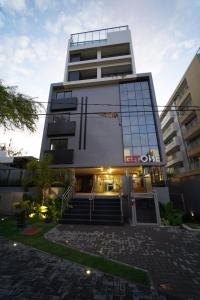 a tall building with a staircase in front of it at Get One in Tambaú