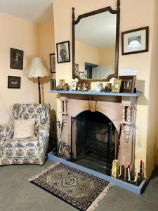 a living room with a fireplace and a mirror at Woodvale at Cooma in Cooma