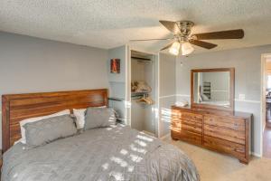 a bedroom with a bed and a ceiling fan at California Vacation Rental with Full Kitchen and Yard! in Bakersfield