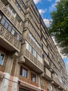 a building with ornate balconies on the side of it at Золотой квадрат 60 кв2 in Almaty