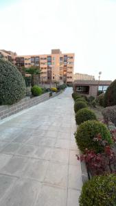 a walkway in a building with bushes and buildings at Madrid Encanto , Barajas , Aeropuerto, IFEMA in Madrid