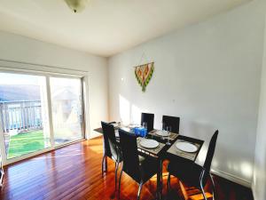 a dining room with a table and chairs and a large window at Big 3 bedrooms 2 stories townhouse Near Downtown in Halifax