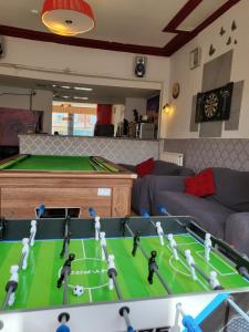 a living room with a pool table and a table at Tulip Hotel Blackpool in Blackpool