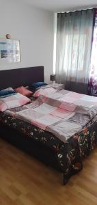 a bedroom with a large bed with a quilt on it at Apartment to stay in Wernau