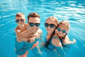 a group of people swimming in the water at Lovely 4 Berth Holiday Home At Felixstowe Beach Holiday Park Ref 55008yc in Walton