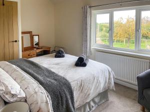 a bedroom with a bed with towels on it at Old Alton Hall Farmhouse in Tattingstone