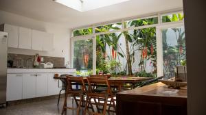 a kitchen with a table and chairs and a large window at La Jardinatta in Bucaramanga