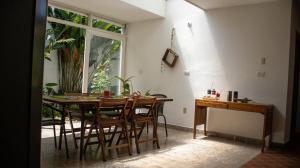 a dining room with a table and chairs and a window at La Jardinatta in Bucaramanga