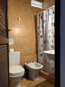 a bathroom with a toilet and a sink at Hotel Cactus Cerro in Purmamarca