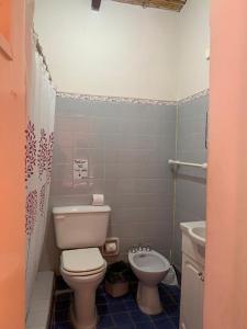 a bathroom with a toilet and a sink at Hotel Cactus Cerro in Purmamarca