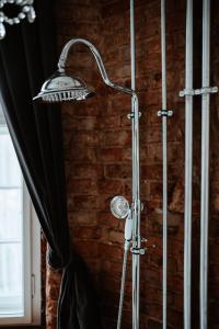 a shower with a shower head in a room at design LOFT 22 in Warsaw