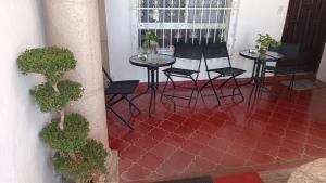 a room with two tables and chairs on a red tile floor at Casa Calis Cancún in Cancún