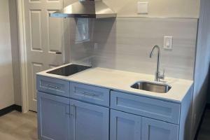 a kitchen with blue cabinets and a sink at Quality Inn Tracy I-205 in Tracy