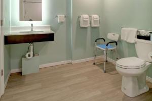 a bathroom with a toilet and a sink at Quality Inn & Suites in Lincoln