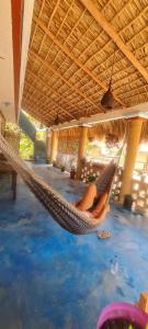 a woman laying in a hammock in a resort at Casa Choco in Mazunte