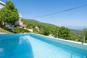 a swimming pool with a view of a mountain at Holiday Home Elisa in Zagorje