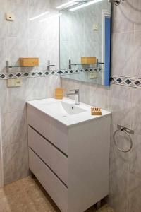 a bathroom with a sink and a mirror at Apartamento vista mar en SAgaró a 100m playa in Sant Feliu de Guixols +34 photos