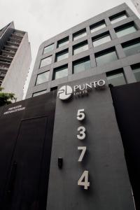 a building with a sign on the side of it at Punto Lofts Periférico Sur in Mexico City