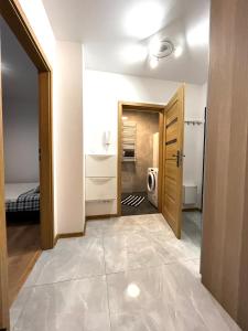 a room with a bathroom with a sink and a door at Downtown Apartment in Krakow
