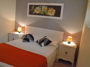 a bedroom with a bed with two lamps on tables at Apartamentospedroche Sitges in Sitges +6 photos