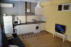 a kitchen with a washer and dryer in a room at Apartamentospedroche Sitges in Sitges