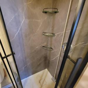 a shower with a glass door in a bathroom at Southview Motel in Westlock