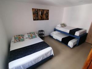 two beds in a small room with at Ocean blue Ed Conquistador in Cartagena de Indias +25 photos