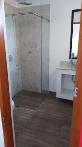 a glass shower in a bathroom with a sink at HOTEL CASCADA PLAZA in Santa Fe de Antioquia +51 photos