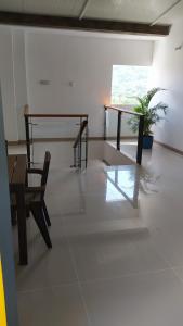 a room with a table and a bench and a plant at HOTEL CASCADA PLAZA in Santa Fe de Antioquia