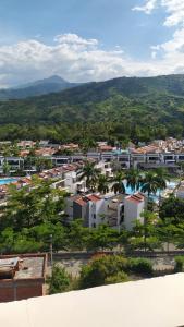 an aerial view of a city with palm trees and buildings at HOTEL CASCADA PLAZA in Santa Fe de Antioquia