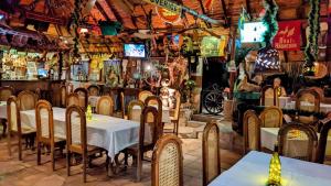 a restaurant with tables and chairs and televisions at Charly's Guest House in Granada