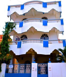 a building with blue shutters on it at Holi-Wood Guesthouse in Puducherry