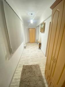 a hallway with a door and a rug on the floor at Shirakatsi Guest House in Gyumri